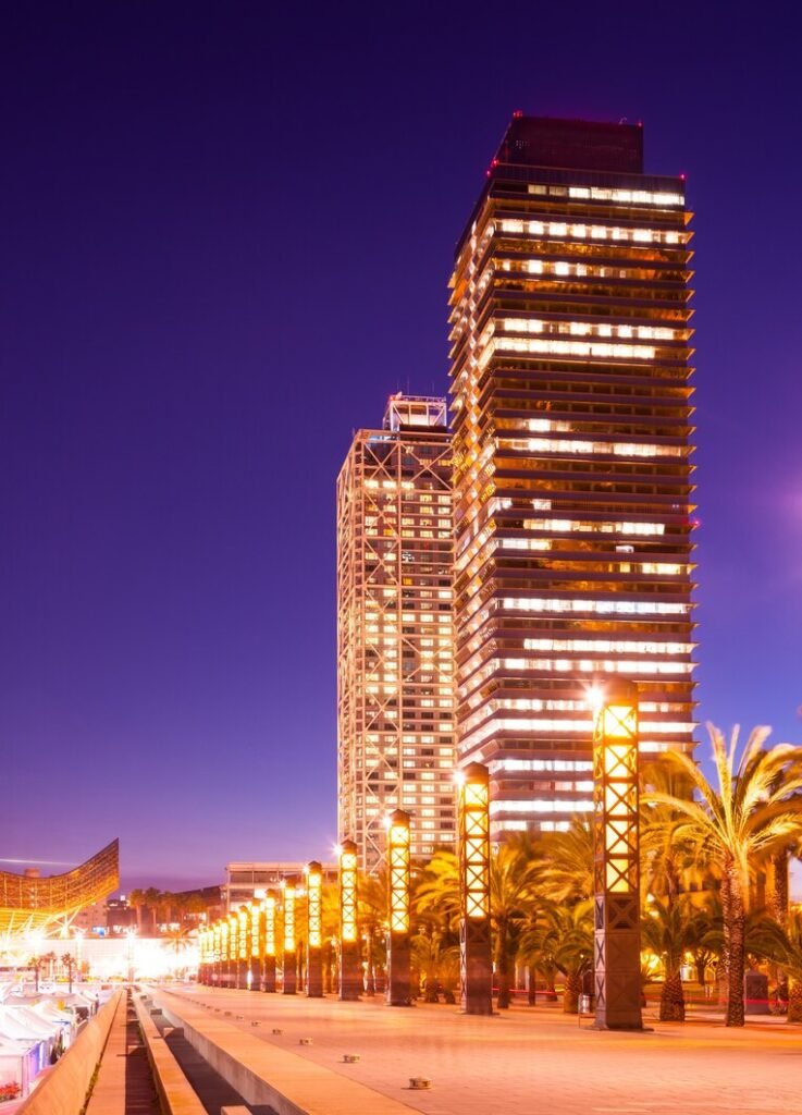 Night view of skyscrapers near Port Olímpic waterfront